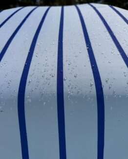 Photo of water beading up on an umbrella in the pool