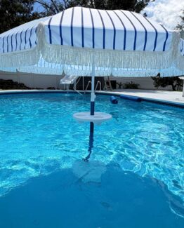 Photo of an umbrella with tassels in the relaxation station in the pool