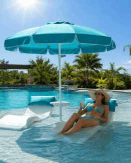 Woman under Baja Table in Sun2 - photo of woman on a lounge chair in the pool under the best in pool umbrella the Baja table