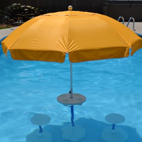 swimming pool tabe with umbrella and chairs Aqua Party Bar