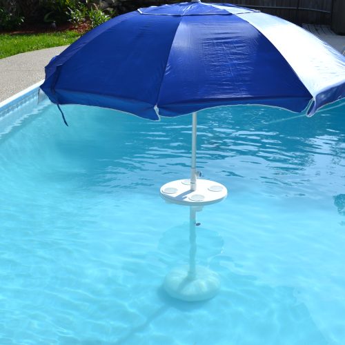 Table in swimming pool with umbrella