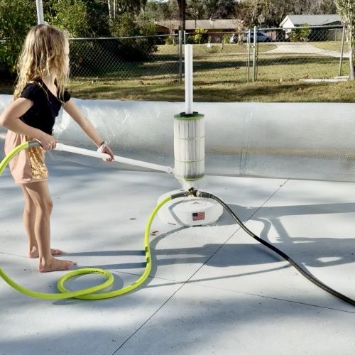 Photo of girl cleaning a pool filter